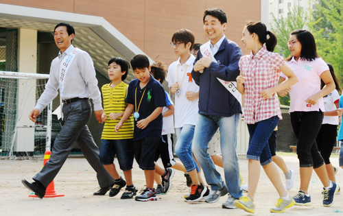 서울 창일초는 등교와 함께 운동장을 한 바퀴 돌며 상쾌한 아침을 시작 할 수 있도록 지도하고 있다. 아이들과 조깅하며 이야기를 나누고 있는 이주호 장관(오른쪽 세번째)과 송신철 교장(왼쪽 첫번째).