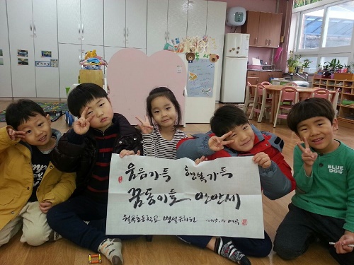 대구월곡초병설유치원 만 3~4반 아이들이 장은숙 교사가 신청해 받은작품을 받아들고 웃고 있다.