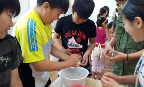 청안초 6학년 김진우(왼2번째), 김영수(가운데) 학생이 치즈를 손으로 모양을 다듬고 있습니다.